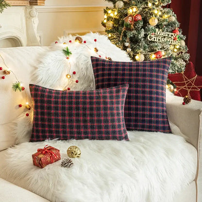 Two decorbites christmas plaid cushion covers in navy and red plaid resting on a white fur couch for home decor