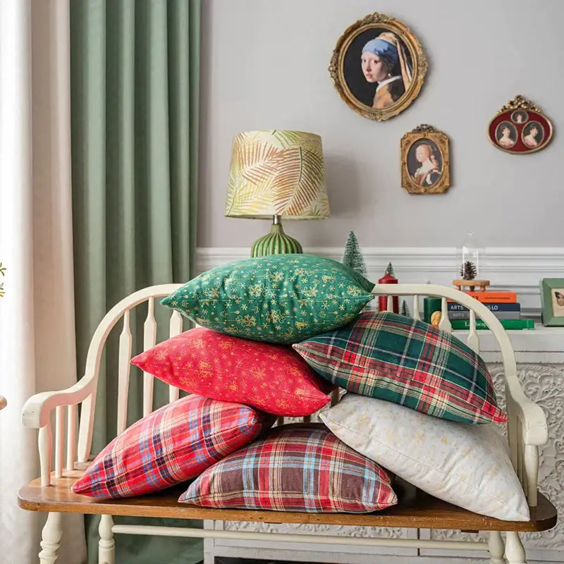 Stack of decorbites christmas plaid cushion covers in red green white and brown floral and plaid patterns for festive decor