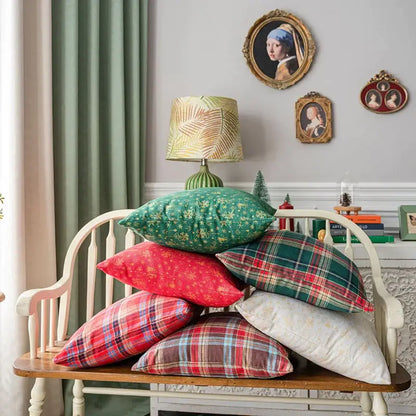 Stack of decorbites christmas plaid cushion covers in red green white and brown floral and plaid patterns for festive decor