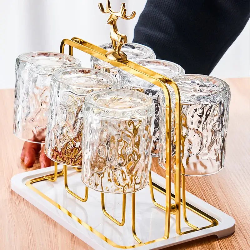 Gold-toned deer-head cups holder set with six textured clear glass cups for drying and decoration by decorbites