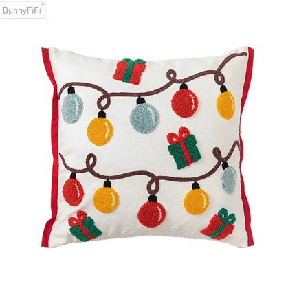 White cotton pillow cover with red trim featuring colorful festive embroidered christmas lights and gift boxes decorbites christmas santa snowflake
