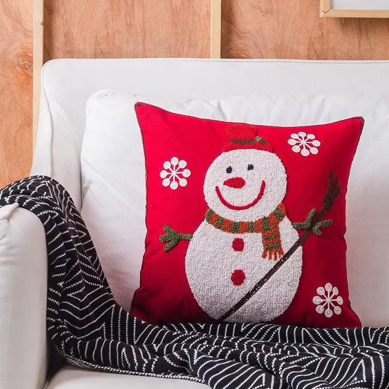 Red cushion with textured white snowman and embroidered white snowflakes in decorbites christmas snowflake elk design