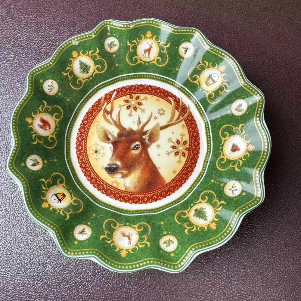 A festive green ceramic serving dish from decorbites christmas tableware featuring a deer and red snowflake patterns