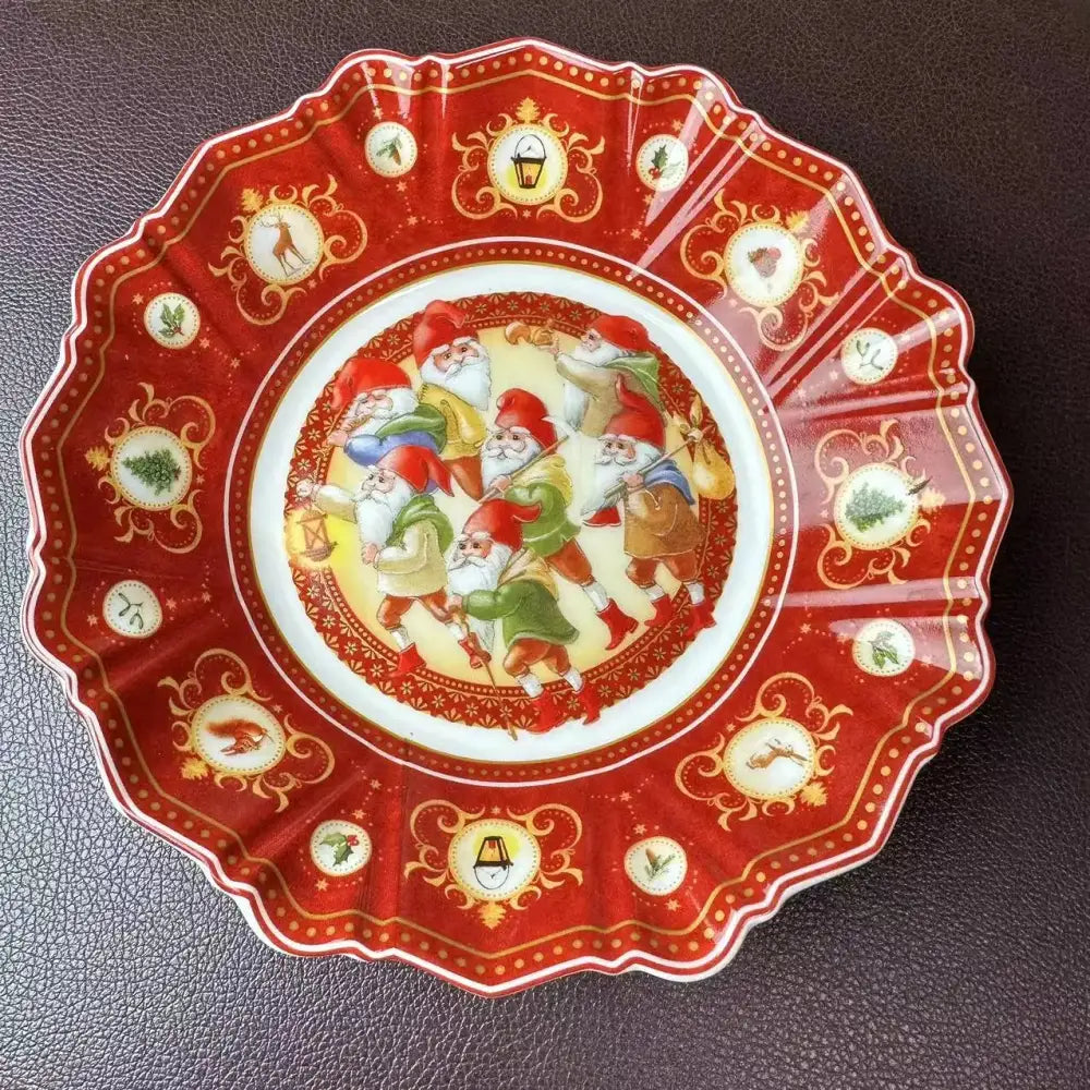 A festive red ceramic plate with scalloped edge featuring seven dwarfs and gold accents from DecorBites Christmas tableware