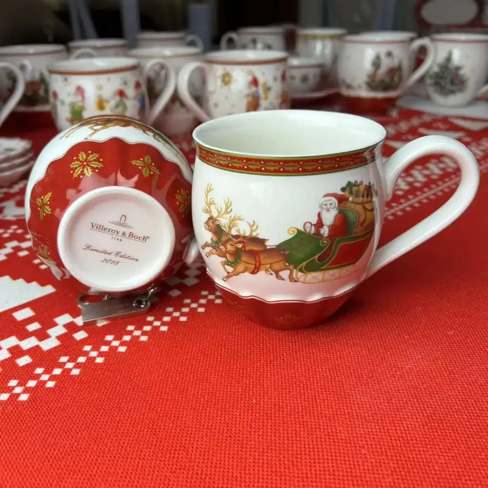 A festive red and white porcelain mug with santa and reindeer gold accents from decorbites christmas tableware