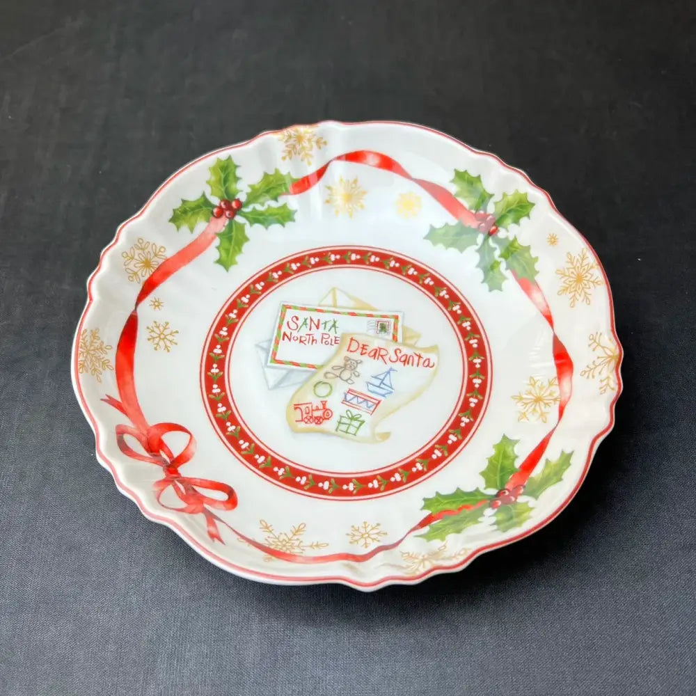 A festive white ceramic plate with scalloped edge and holiday design from decorbites christmas tableware set