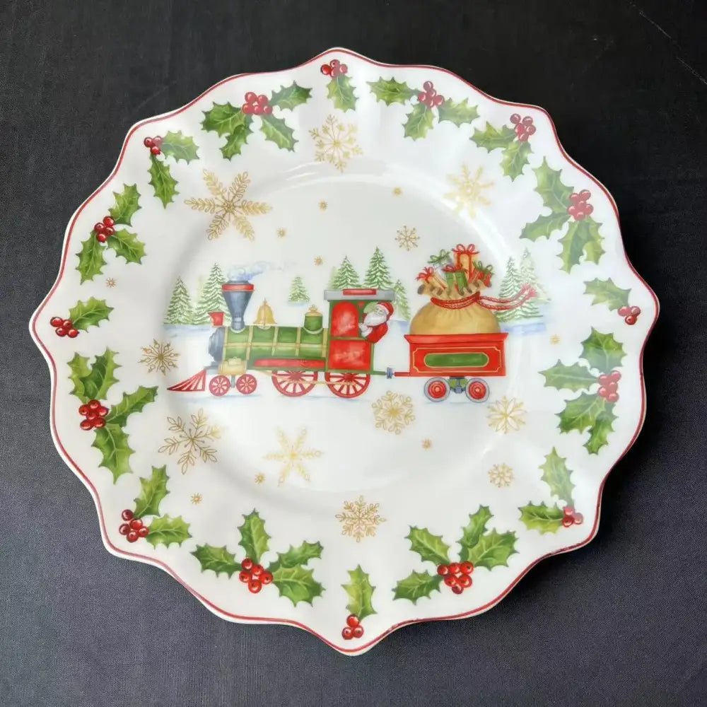 White ceramic plate with scalloped edge featuring festive christmas train design and holly from decorbites christmas tableware