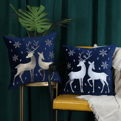 Navy blue DecorBites™ cushion cover with embroidered white and silver deer and snowflake christmas tree patterns