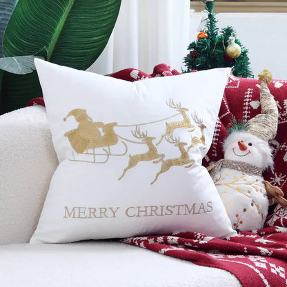 White christmas-themed cushion cover with gold embroidered sleigh, reindeer, and merry christmas text for festive decor