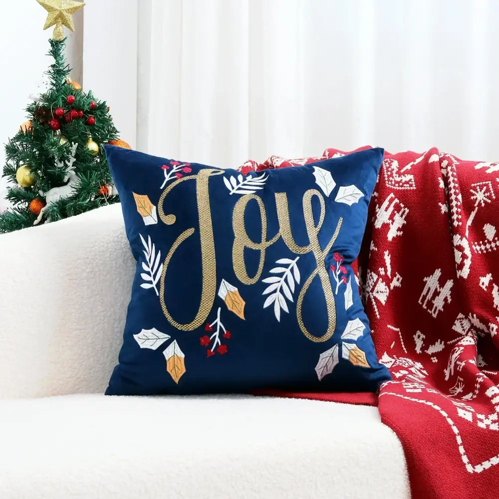 Navy blue decorbites™ christmas tree cushion cover with gold and white embroidered joy lettering and leafy embellishments