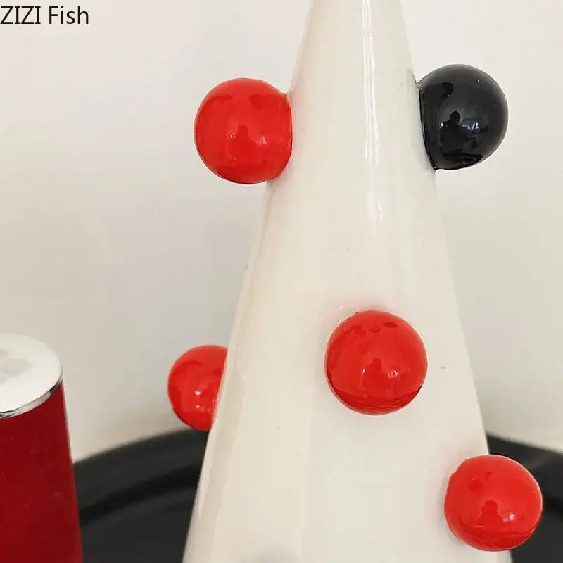 White ceramic DecorBites Christmas tree jewelry stand with glossy red and black beads for necklace and earrings display