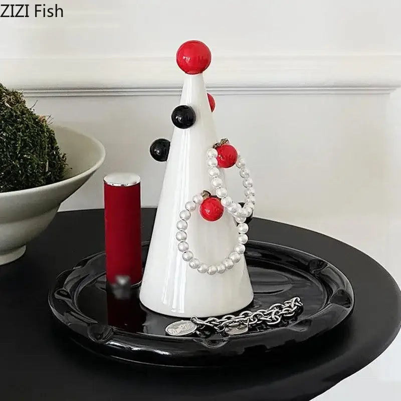 White ceramic christmas tree jewelry stand by DecorBites adorned with red and black spherical ornaments for elegant storage
