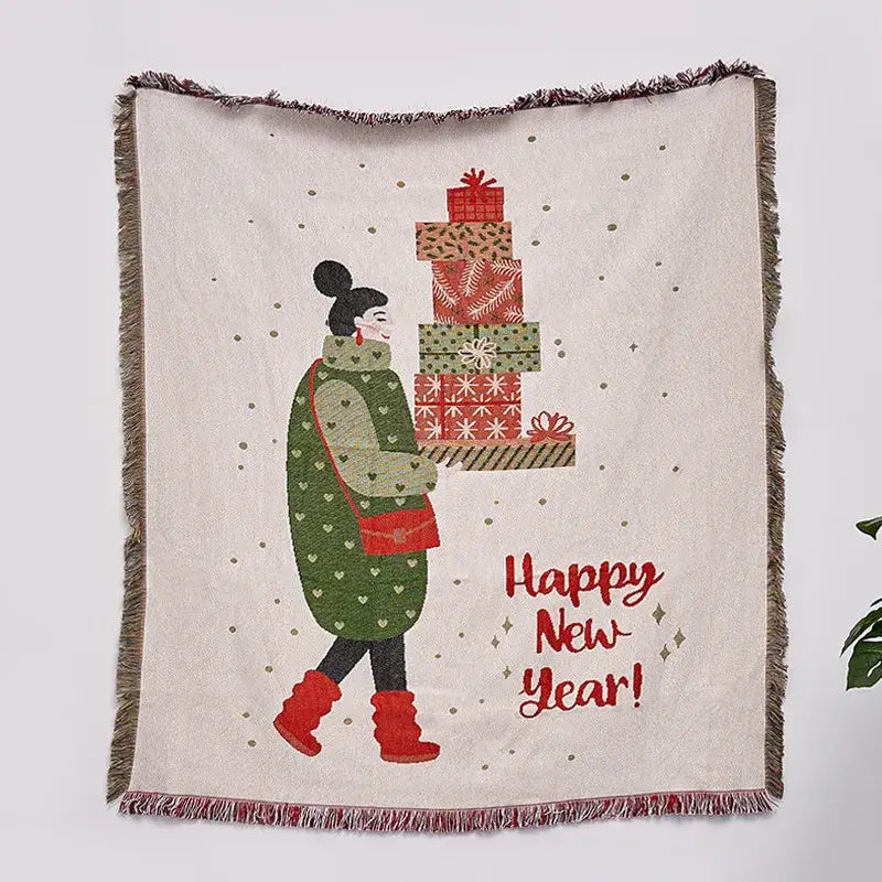 A cream-colored decorbites christmas tree knitted throw blanket with fringed edges and festive holiday illustration