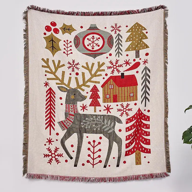 A beige woven decorbites christmas tree knitted throw blanket featuring a gray deer with festive christmas motifs