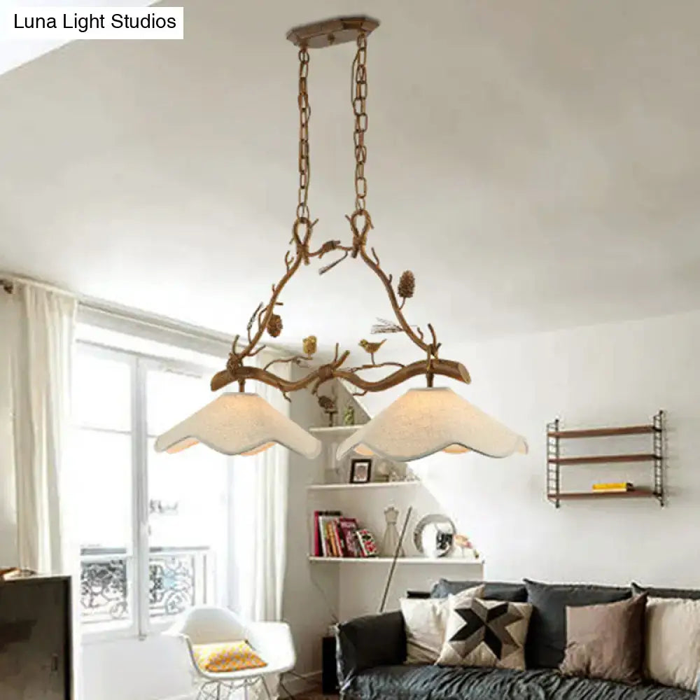 Decorbites classic resin branch suspension light in rustic bronze with two cream scalloped shades and decorative pinecones