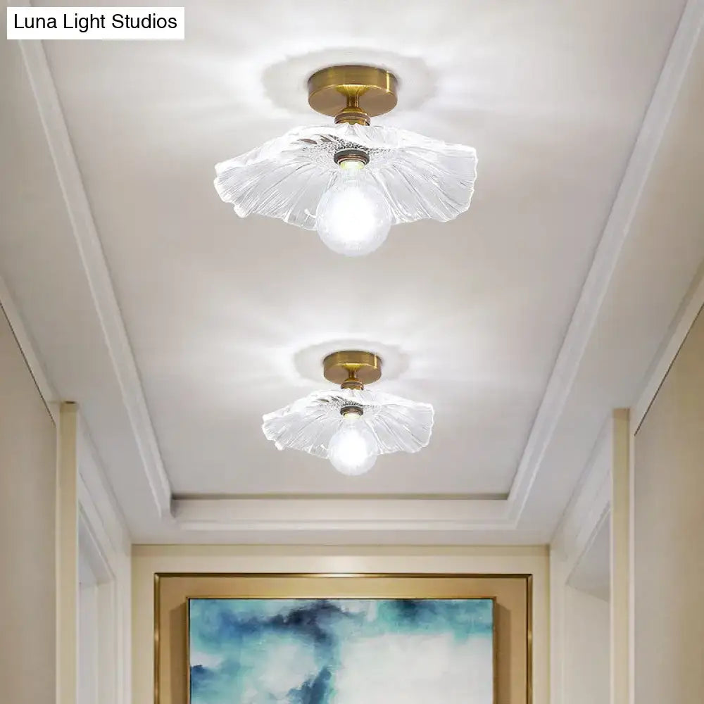 Two elegant brass finished flush mount glass ceiling lights with translucent fluted shades and brass lamp holders for corridors