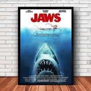 Black-framed jaws movie poster canvas featuring a menacing shark above a swimmer for classic wall art decor