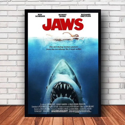 Black-framed jaws movie poster canvas featuring a menacing shark above a swimmer for classic wall art decor