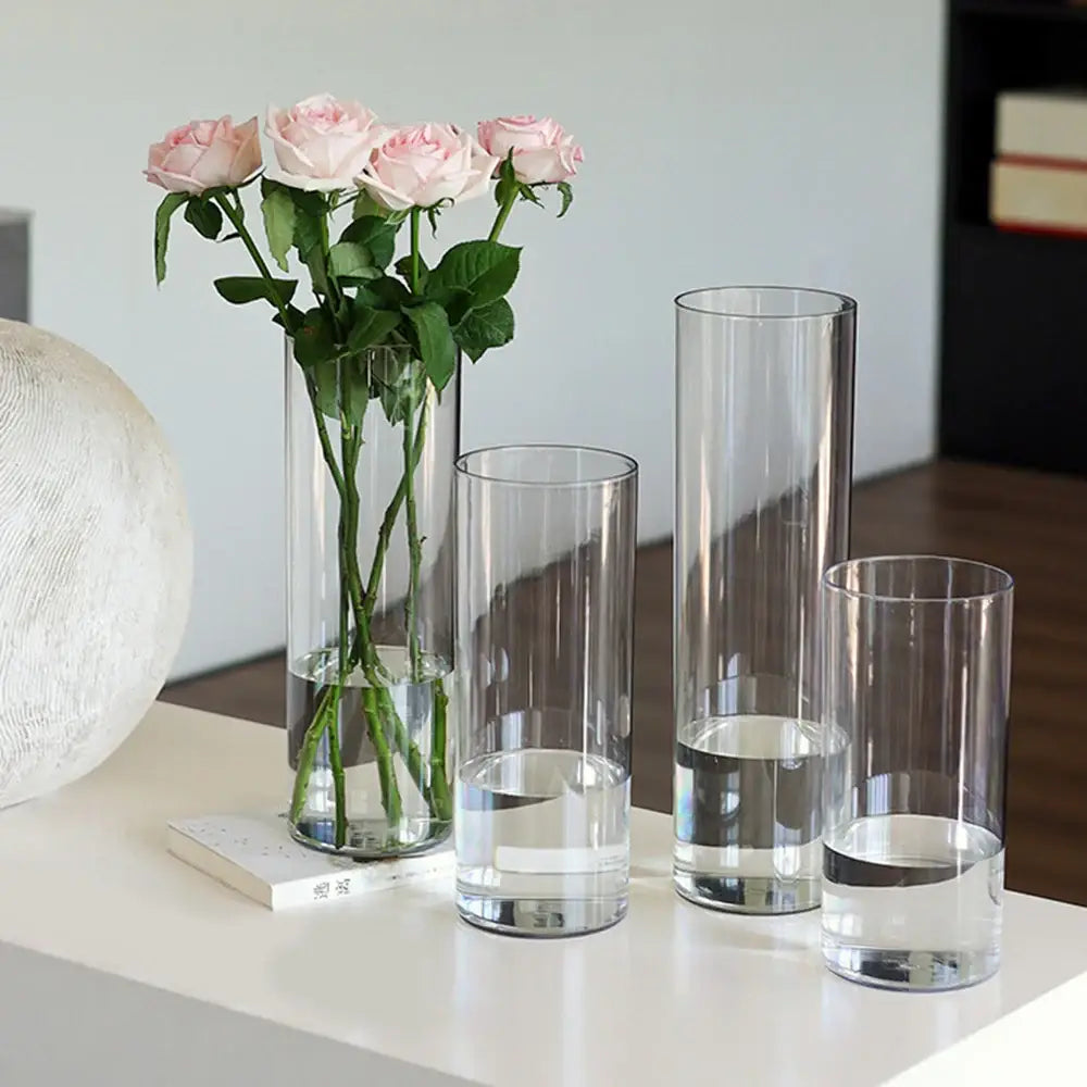Clear acrylic hurricane flower vases of varying heights with pink roses showcasing the DecorBites large flower vase