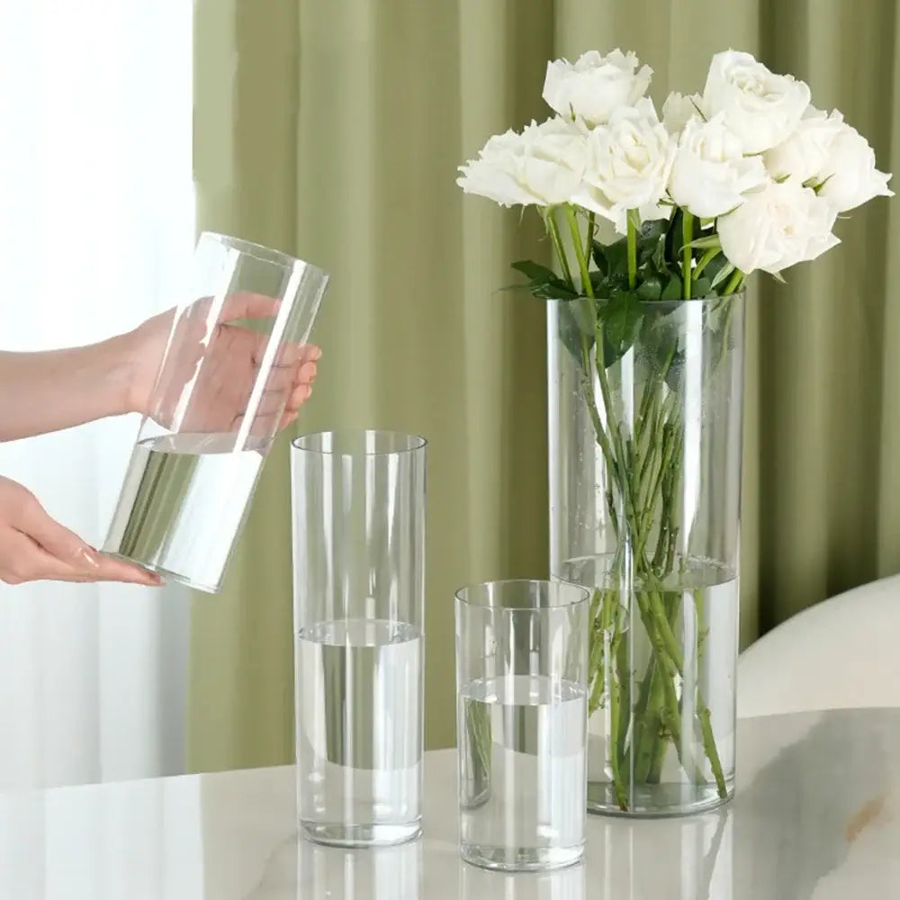 Tall clear acrylic hurricane flower vases of varying heights on a reflective surface by decorbites large size