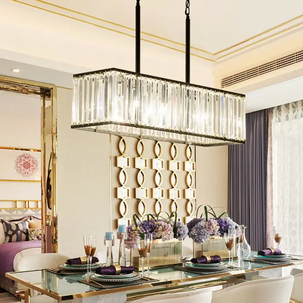 Rectangular clear crystal island pendant light with black metal frame and hanging chains for modern dining rooms