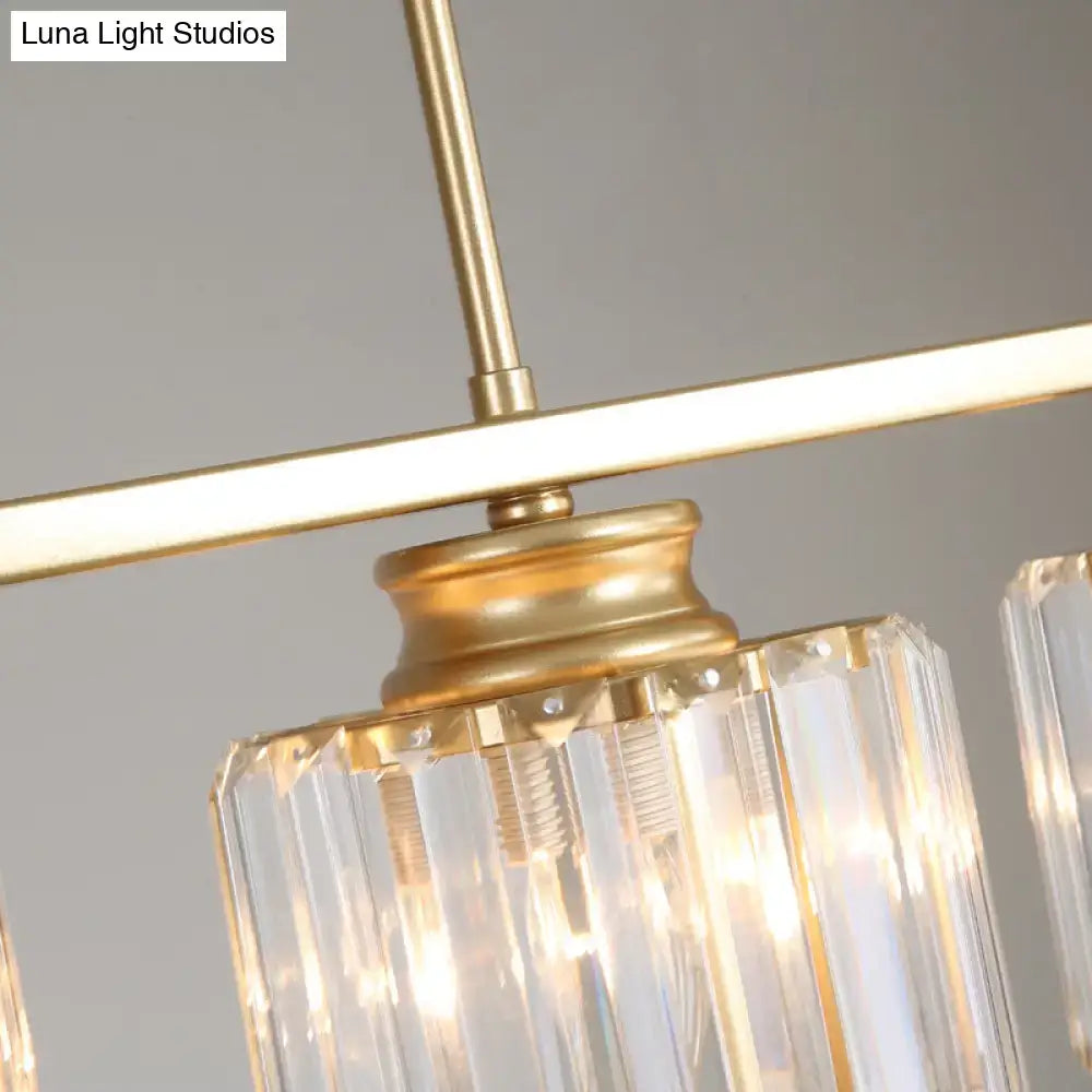 Gold finished metal frame clear crystal prisms decorate the DecorBites island light elegant country cylinder hanging fixture