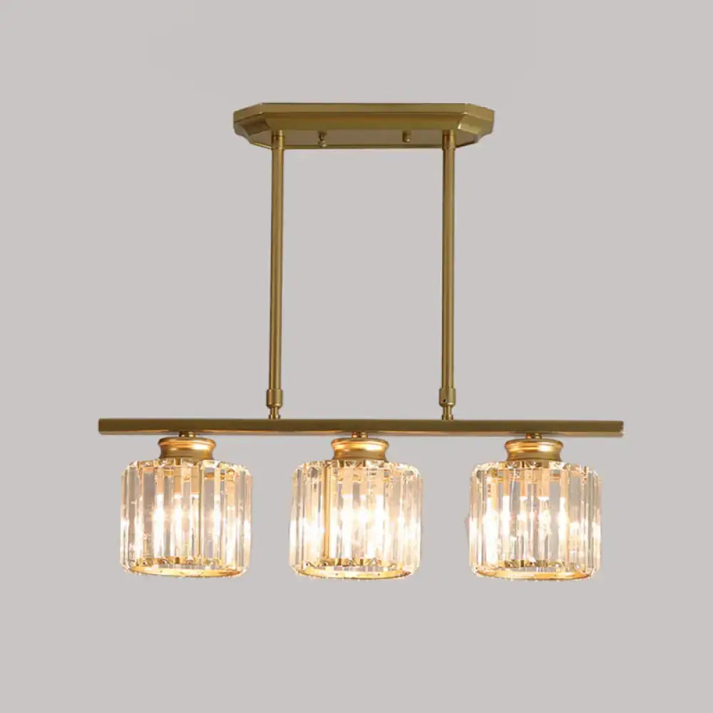 Gold-toned DecorBites™ clear crystal island light with three cylindrical country cylinder hanging shades for dining room