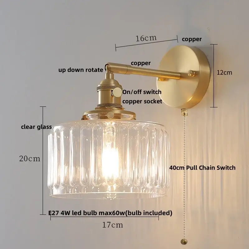 Vintage-style wall lamp with brass finish and clear flower glass shade by Decorbites for bedroom use with pull chain