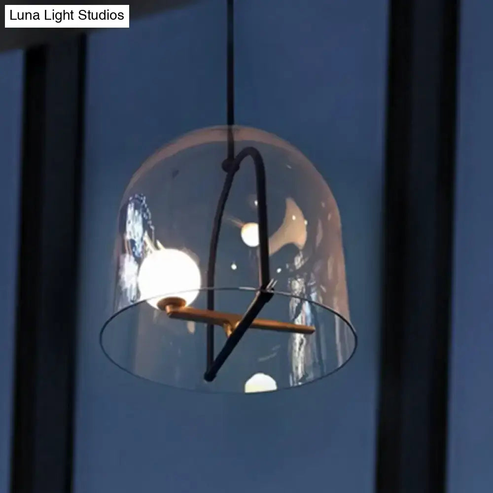 DecorBites clear glass cylinder pendant light with black metal frame and gold accents for modern living room