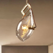 DecorBites clear glass fish pendant light with brass clamp and exposed filament bulb for modern restaurant lighting