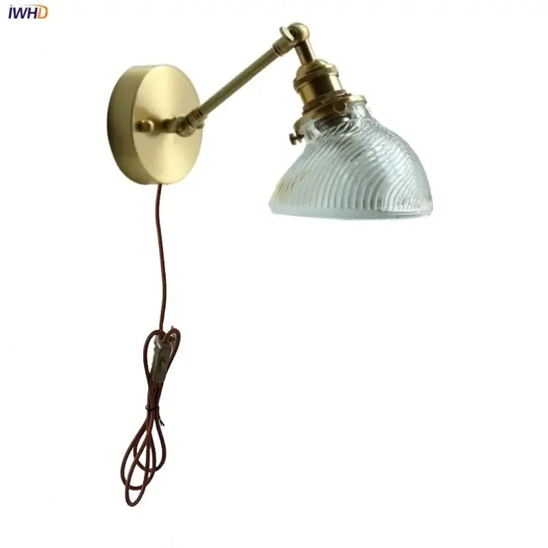 Brass-finished adjustable wall sconce with ribbed clear glass shade and brown cord by Decorbites clear glass led light