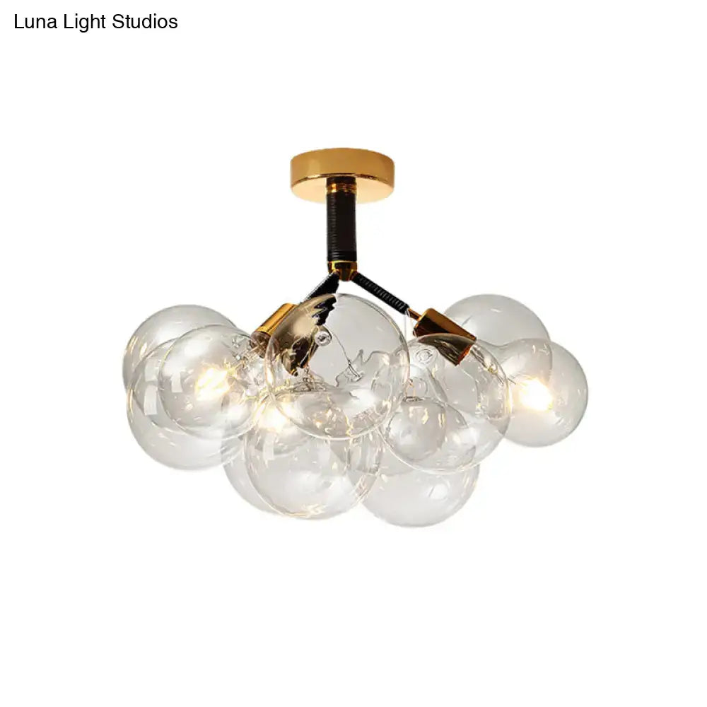 DecorBites™ semi flush ceiling light with clear glass globes and brass arms on gold-toned base for foyer illumination