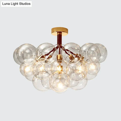 Gold-toned decorbites semi flush ceiling light with clear glass bubble design for foyer and corridor illumination