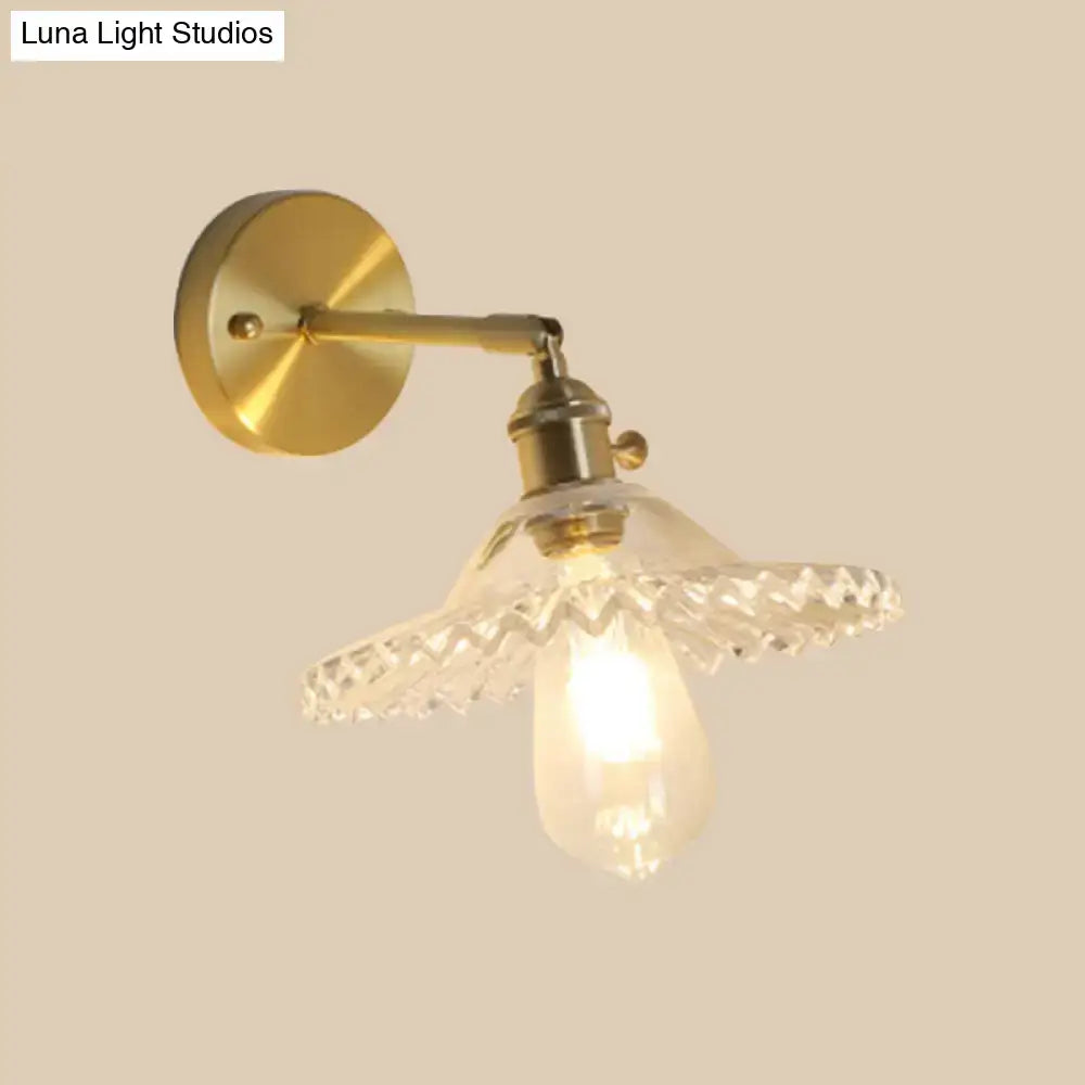 Gold-toned industrial brass wall sconce with clear faceted glass shade and exposed e26 e27 bulb for living room lighting