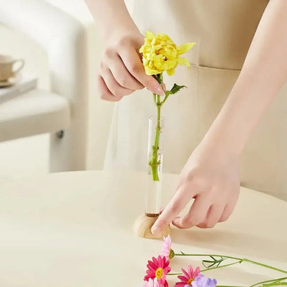 Decorbites clear plastic test tube vase with wooden base holding single yellow flower for home decor