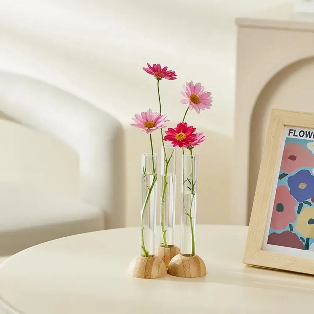 DecorBites clear plastic test tube vase with wooden bases holding pink and red daisies for home decor