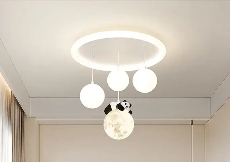 A white circular decorbites cloud bubble ceiling light with three hanging spherical bulbs and a panda figurine