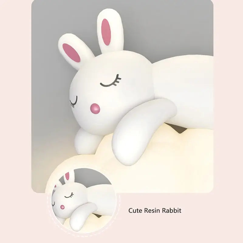 A white resin decorbites cloud bunny figurine with pink ears and nose in a cozy sleeping pose for bedroom lighting