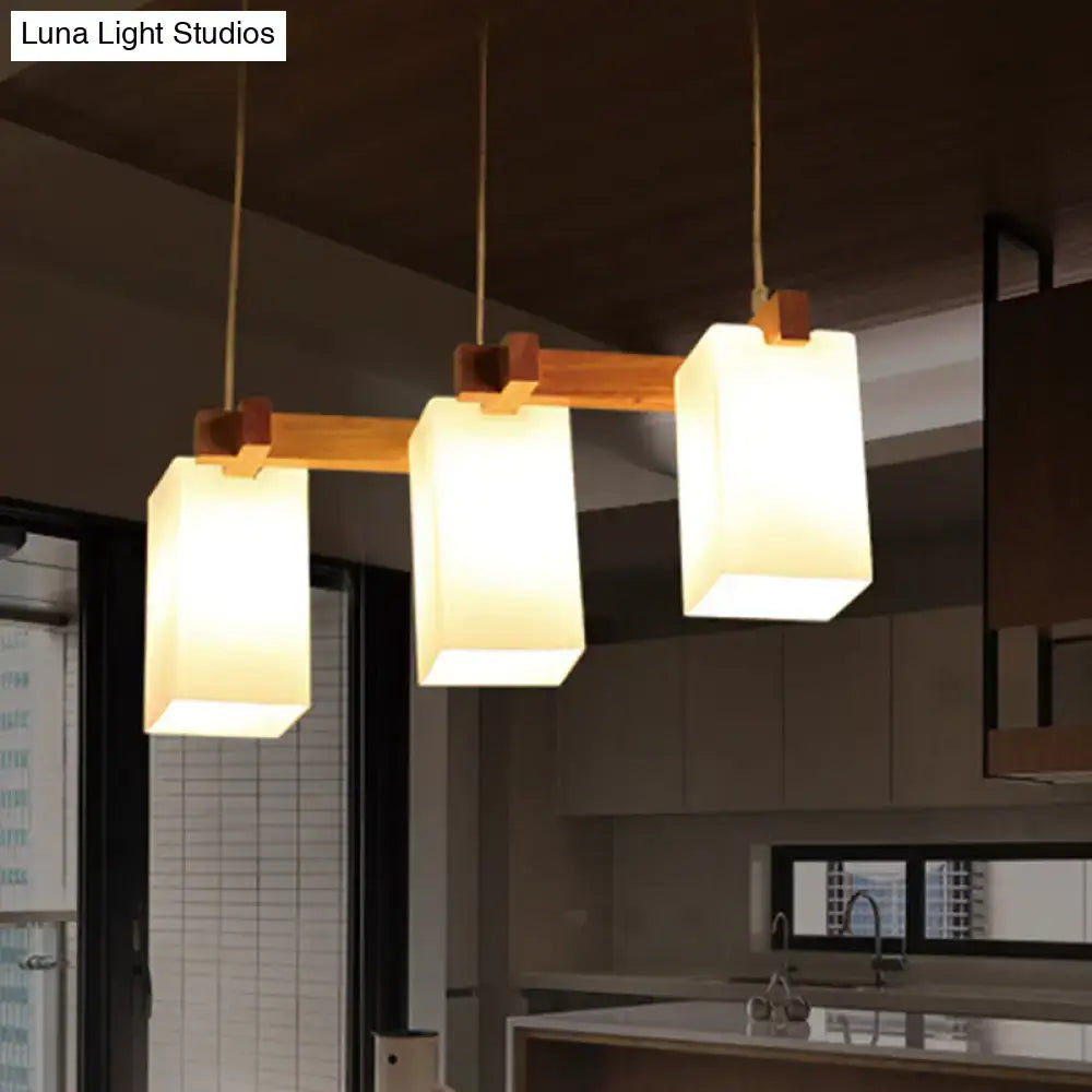 Decorbites cluster pendant kitchen lamp with warm-toned wood frame and white glass shade in a modern design