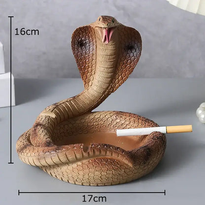 A detailed brown decorbites cobra ashtray made of orange resin with textured scales and an open mouth for cigarette use