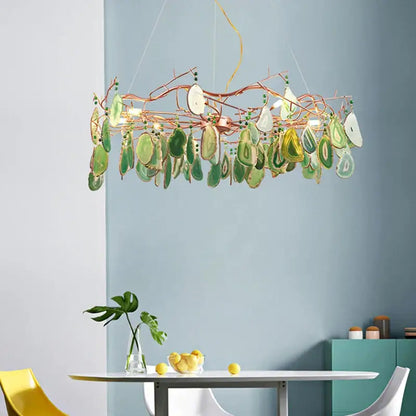 A decorbites colorful agate chandelier featuring copper branches with green and white translucent agate slices for dining room