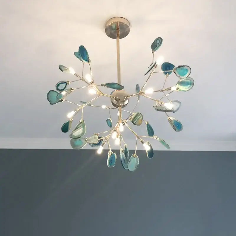 A decorbites colorful agate led bedroom pendant light featuring a gold-toned metal frame with turquoise agate slices