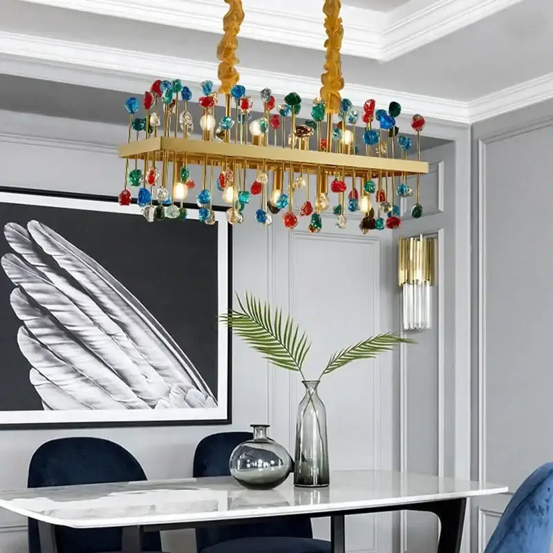 A decorbites colorful crystal chandelier with a gold frame and multicolored orbs for dining room pendant light