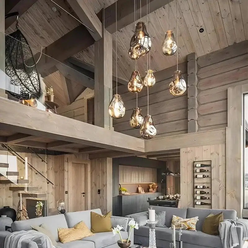 A cluster of amber teardrop-shaped glass pendant lights in decorbites colorful glass chandelier for dining room
