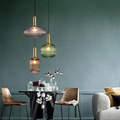 Three colorful glass pendant lights with ribbed translucent bodies in purple green and amber by DecorBites™ for retro style
