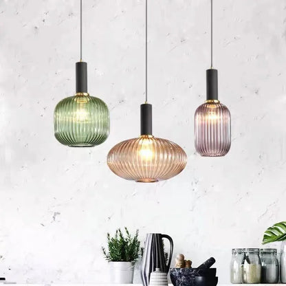 Three colorful glass pendant lights with ribbed green amber and mauve shades for retro style by decorbites
