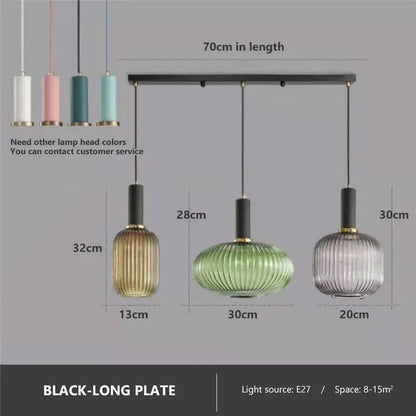Set of three colorful glass pendant lights with ribbed shades in gold, green, and clear hues by DecorBites pendant lights