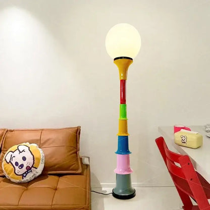 Decorbites colorful memphis floor lamp with a rainbow stacked cylindrical base and white spherical led bulb for bedroom lighting