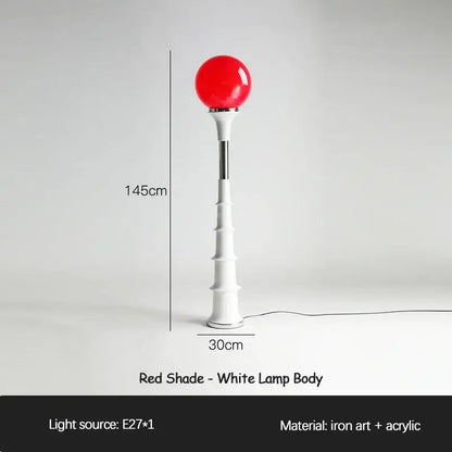 A decorbites colorful memphis floor lamp with a red spherical shade and white ridged base for bedroom lighting