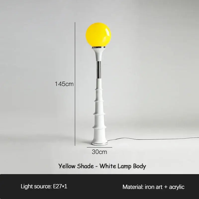 A decorbites colorful memphis floor lamp with a yellow spherical shade and white bamboo-inspired iron base for bedroom use